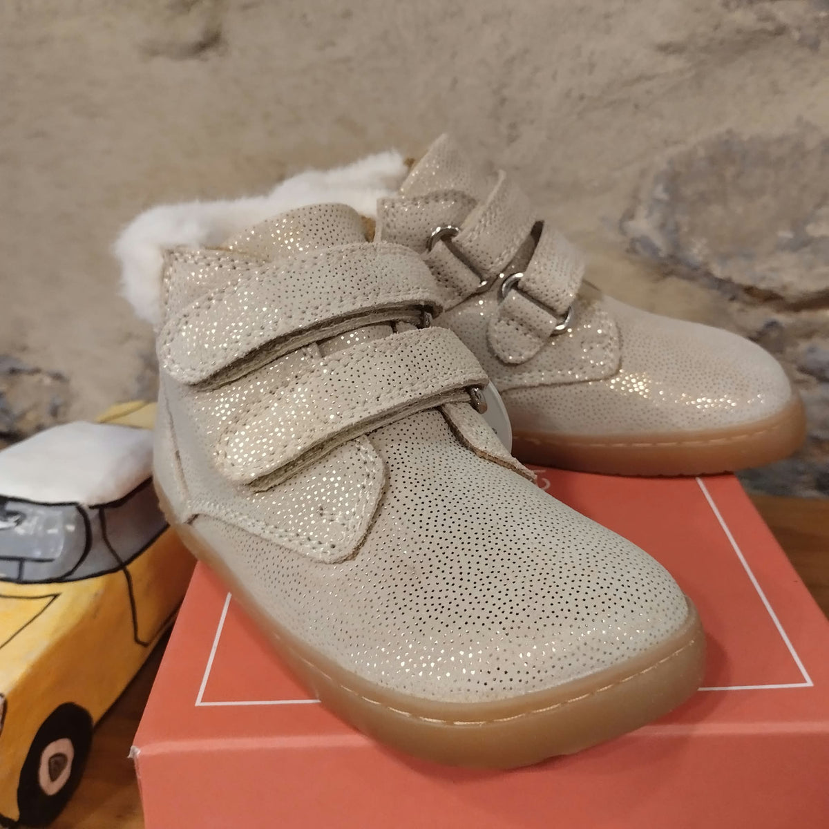 Bota "peques" en cuero. Color oro brillo y pelito a la par del tobillo.